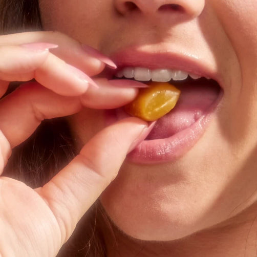 A person placing a manuka honey drop in their mouth. Post from instagram.